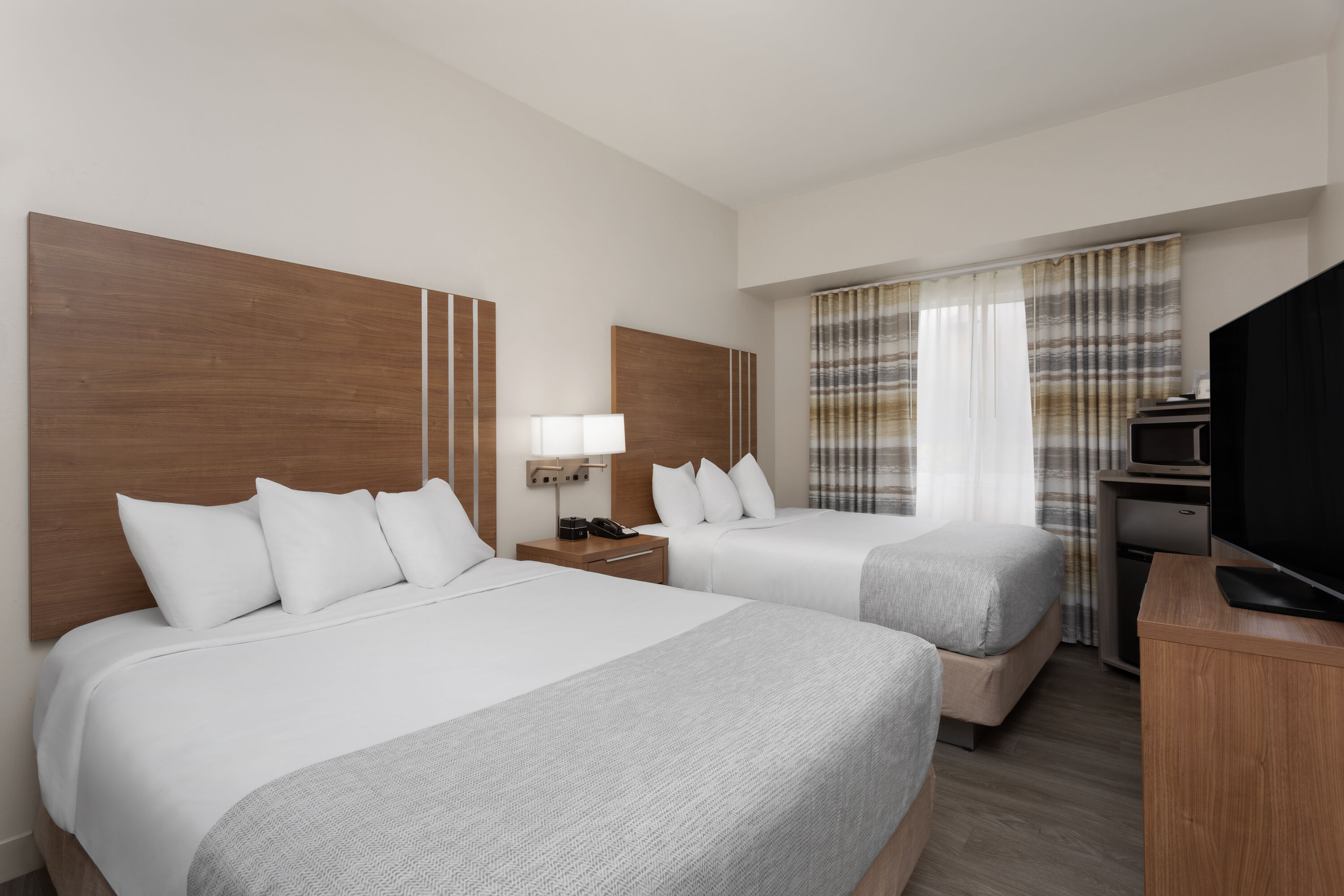 Guest room at the Hawthorn Extended Stay by Wyndham Naples in Naples, Florida