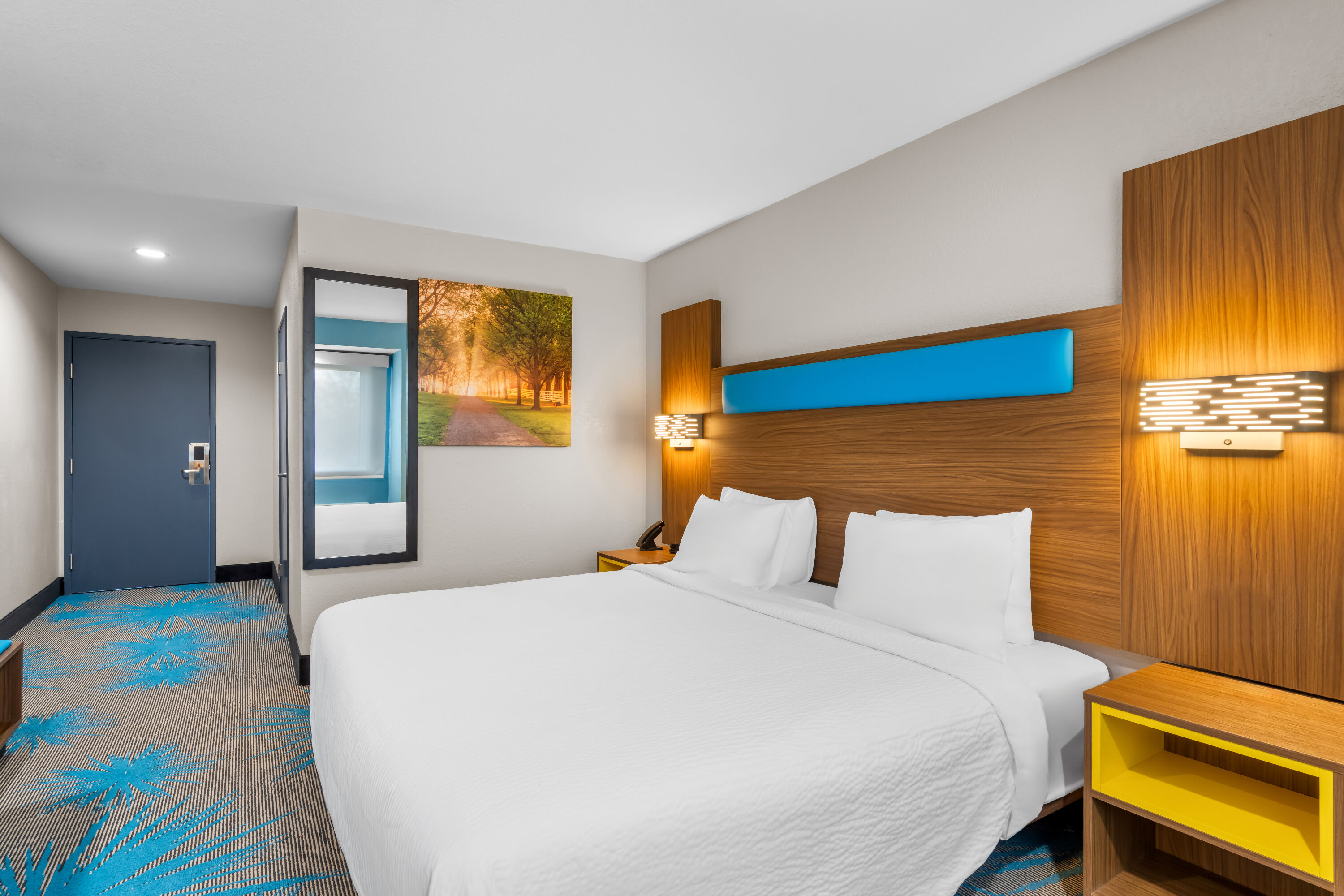 King bed guest room at the Days Inn & Suites by Wyndham Brandon Amphitheater in Brandon, Mississippi