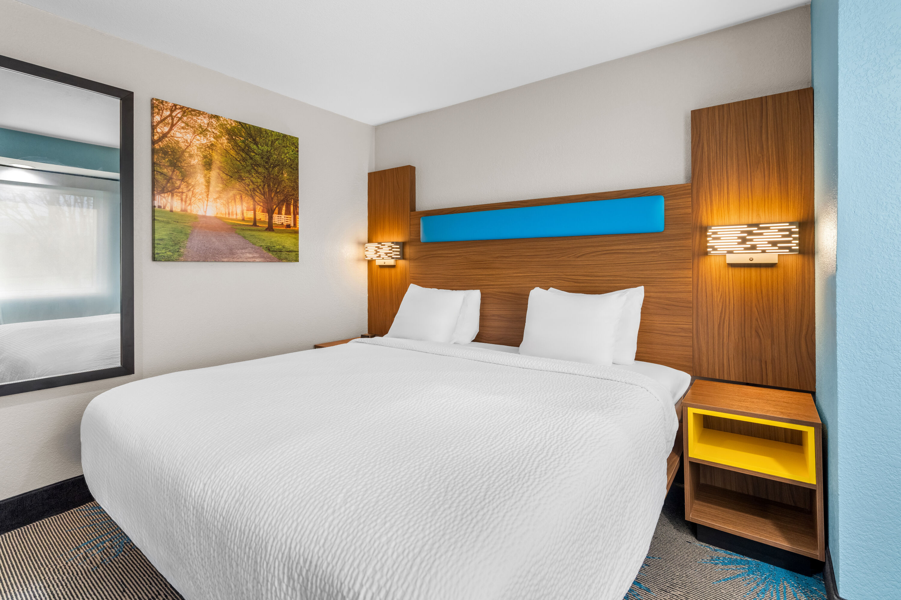 King bed guest room at the Days Inn & Suites by Wyndham Brandon Amphitheater in Brandon, Mississippi