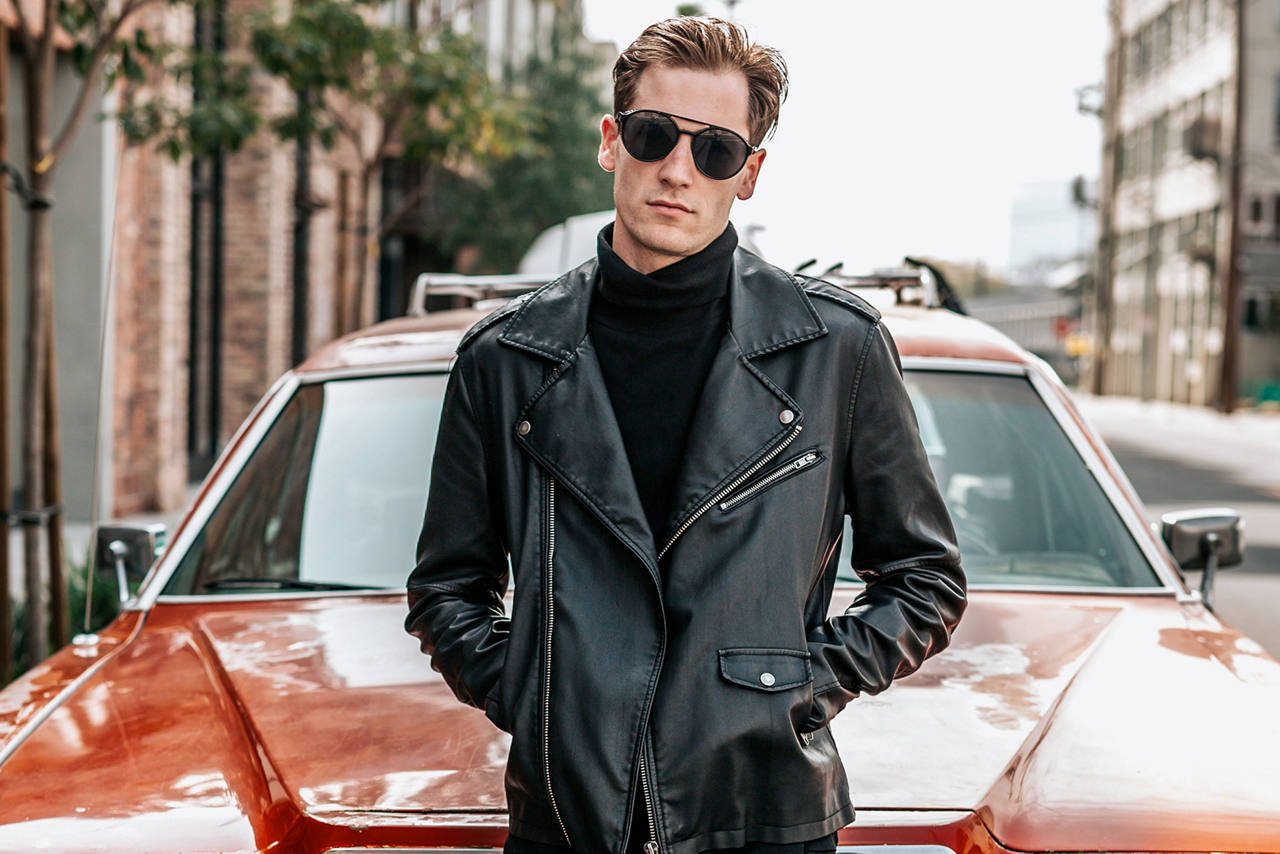 Euro Man in Suit sitting on hood of car