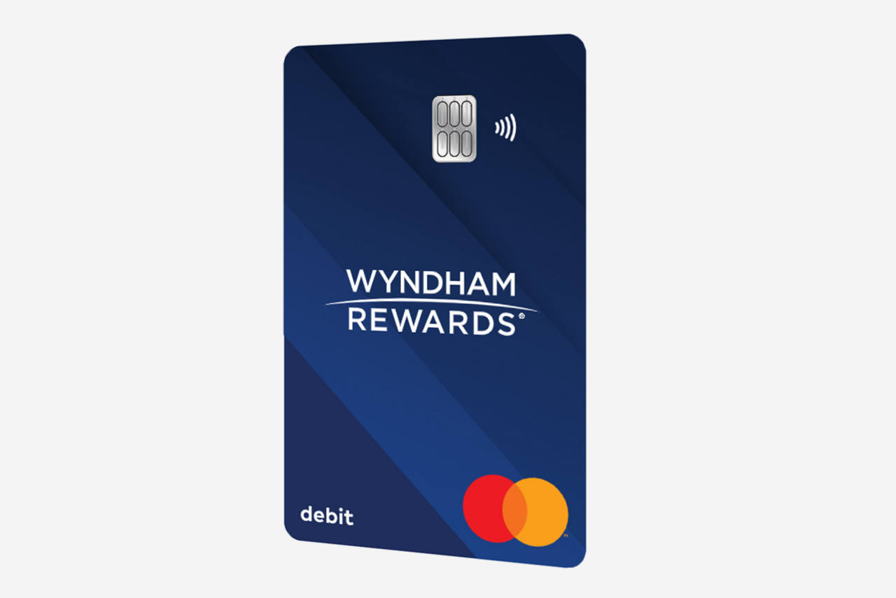 A couple having breakfast in a restaurant. The Dine Out with Wyndham Rewards logo overlayed on the image. 